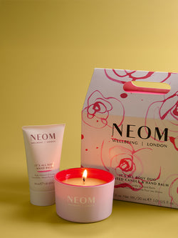 NEOM candle and hand balm set on a yellow background