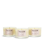 Three NEOM candles on a white background