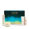 NEOM Wellbeing London skincare and candle set on a white background