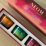 Close-up of NEOM Winter Wellbeing Candle Trio featuring Cosy Nights, Perfect Peace, and Christmas Wish candles.