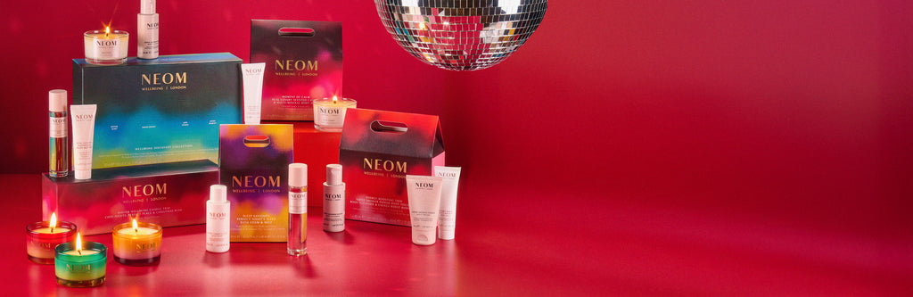 NEOM gift sets products on a red background