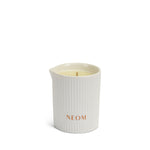 White ribbed candle with 'NEOM' branding on a white background